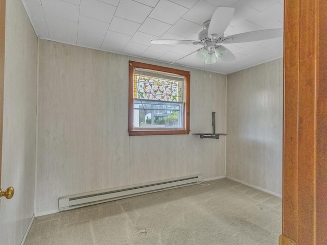 spare room featuring carpet floors, ceiling fan, and a baseboard radiator