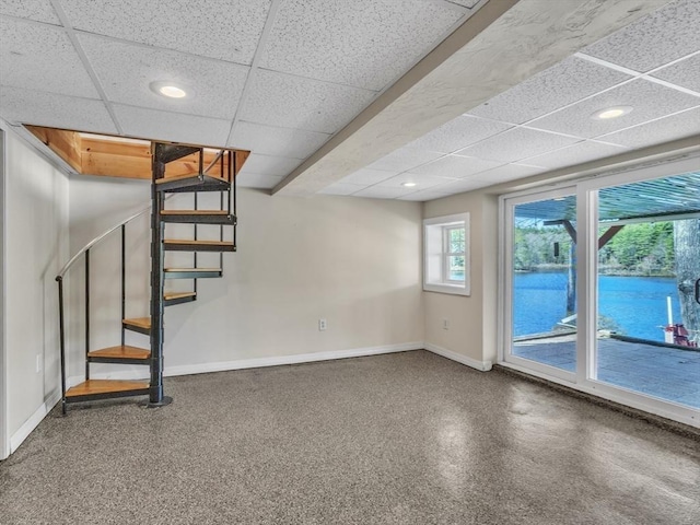 basement featuring stairway, baseboards, recessed lighting, and a paneled ceiling
