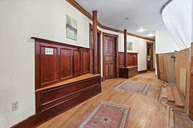 hall featuring ornamental molding and light wood-style flooring