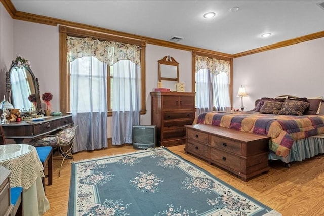 bedroom with crown molding, wood finished floors, and recessed lighting