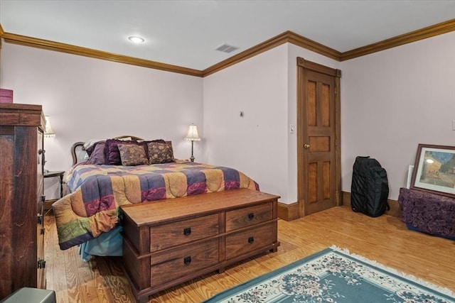 bedroom featuring light wood-style flooring and ornamental molding
