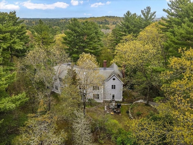 view of subject property featuring a forest