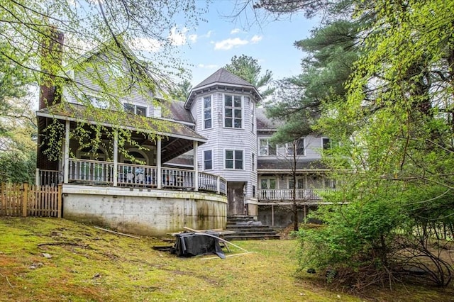 back of house with a chimney, stairs, and a deck