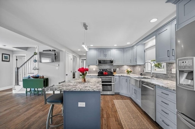 11 Beaver Park, Danvers, MA 01923 - kitchen with appliances with stainless steel finishes, gray cabinetry, backsplash, a kitchen island, and dark wood-style floors