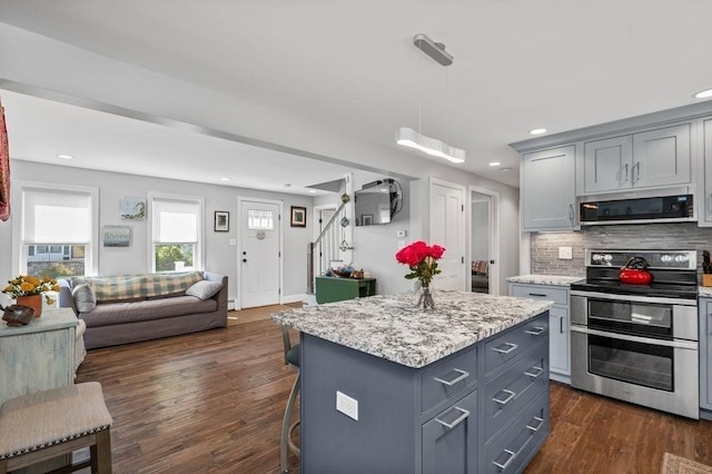 11 Beaver Park, Danvers, MA 01923 - kitchen featuring appliances with stainless steel finishes, gray cabinetry, open floor plan, tasteful backsplash, and dark wood-style flooring
