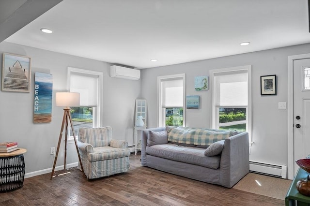 11 Beaver Park, Danvers, MA 01923 - living area with a wall unit AC, a baseboard heating unit, healthy amount of natural light, wood finished floors, and recessed lighting