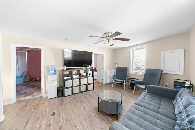 living room featuring ceiling fan and light wood-type flooring