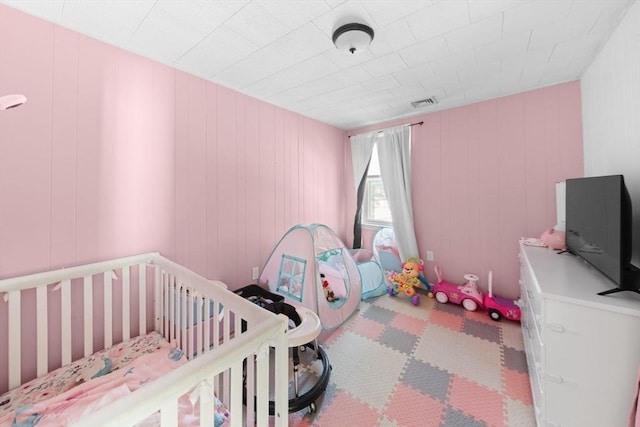 bedroom featuring a nursery area