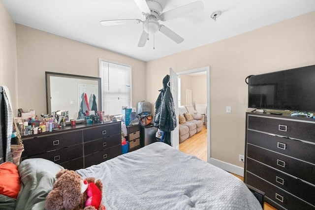 bedroom with ceiling fan and light hardwood / wood-style floors