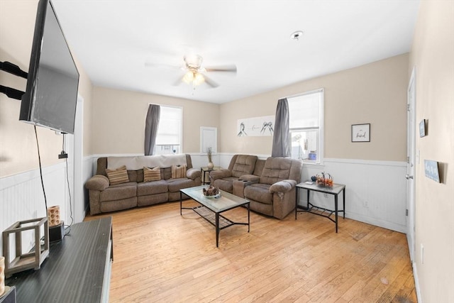 living room featuring ceiling fan and light hardwood / wood-style flooring