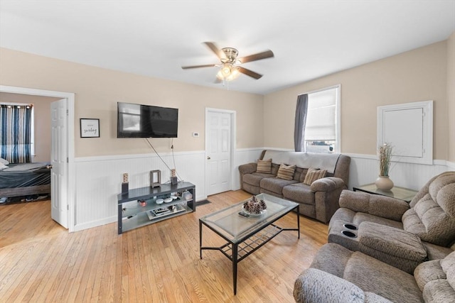 living room featuring ceiling fan and light wood-type flooring