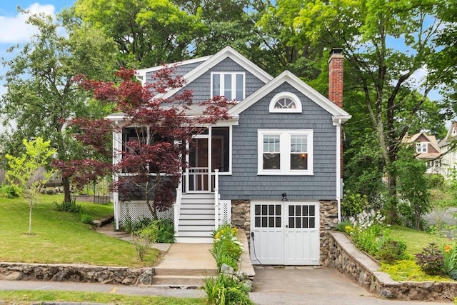61 Fiske Ave, Waltham, MA 02453 - shingle-style home with a chimney, a front yard, and stone siding