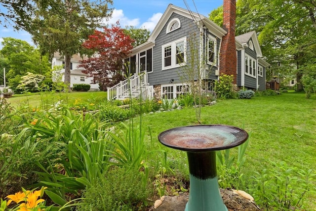61 Fiske Ave, Waltham, MA 02453 - back of house with a chimney, a lawn, and stairs