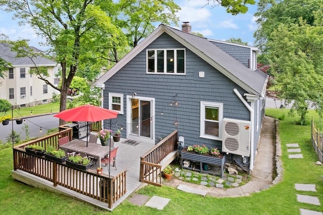 61 Fiske Ave, Waltham, MA 02453 - rear view of house featuring a chimney, a wooden deck, a yard, and outdoor dining area