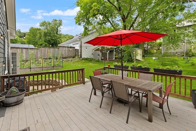 61 Fiske Ave, Waltham, MA 02453 - wooden terrace featuring outdoor dining area and a garden