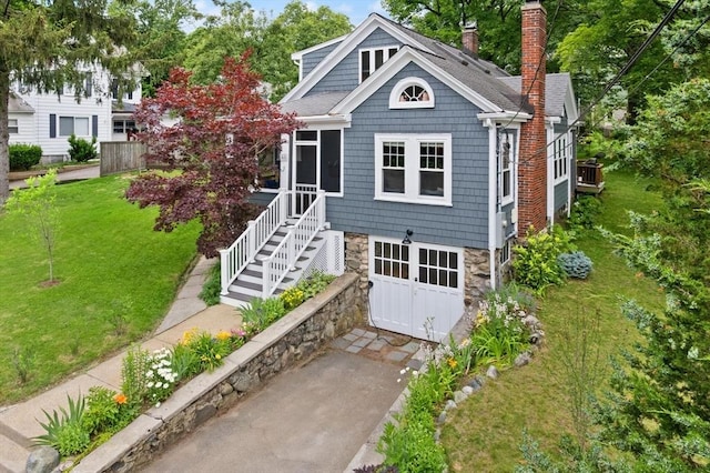 61 Fiske Ave, Waltham, MA 02453 - view of front of house with a chimney, a front lawn, stone siding, and roof with shingles
