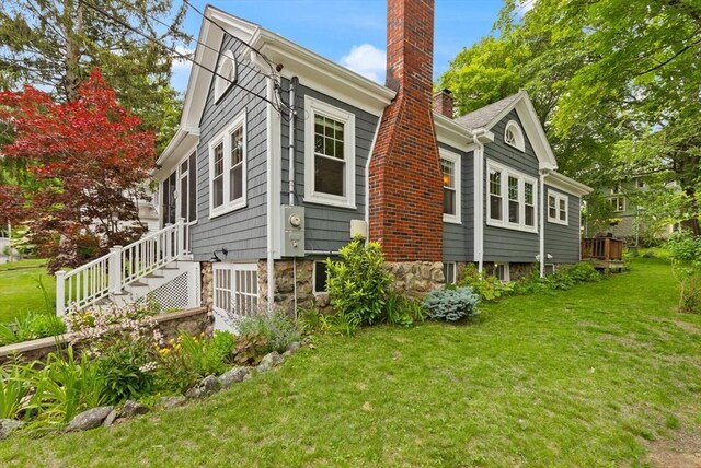 61 Fiske Ave, Waltham, MA 02453 - view of side of home with a chimney, a lawn, and stairs