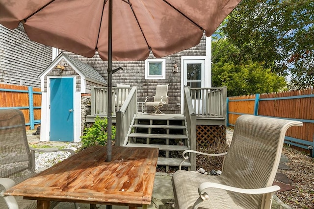 12 Callender Ave, Newport, RI 02840 - view of patio with a wooden deck, a fenced backyard, a storage shed, an outdoor structure, and stairs