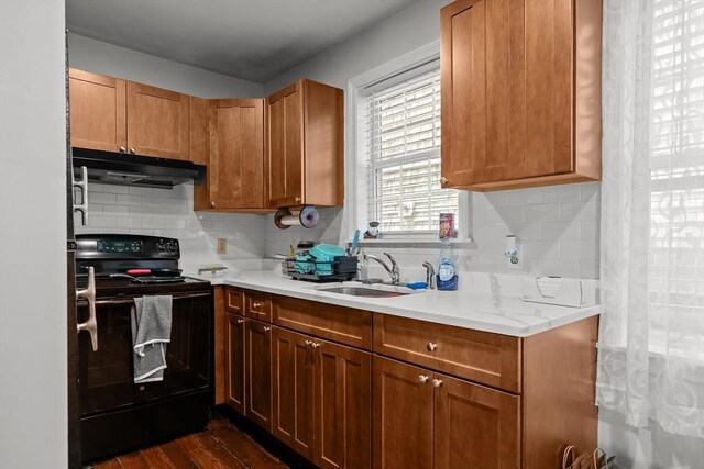 12 Callender Ave, Newport, RI 02840 - kitchen with black range with electric cooktop, under cabinet range hood, light countertops, decorative backsplash, and a sink