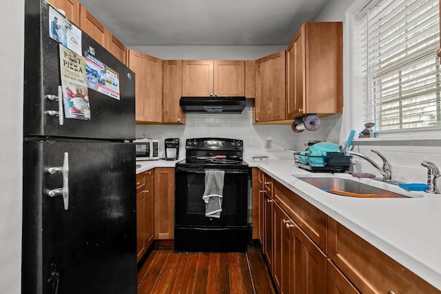 12 Callender Ave, Newport, RI 02840 - kitchen featuring black appliances, under cabinet range hood, a sink, dark wood-type flooring, and decorative backsplash