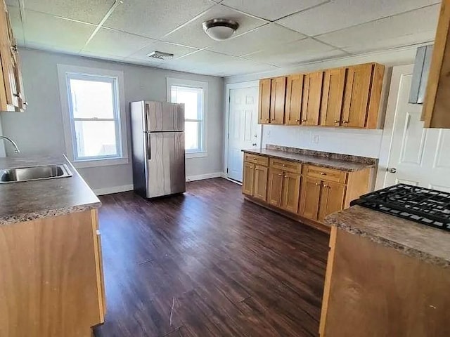 274 Harrison St, Fall River, MA 02723 - kitchen featuring freestanding refrigerator, dark wood-type flooring, brown cabinetry, a paneled ceiling, and plenty of natural light