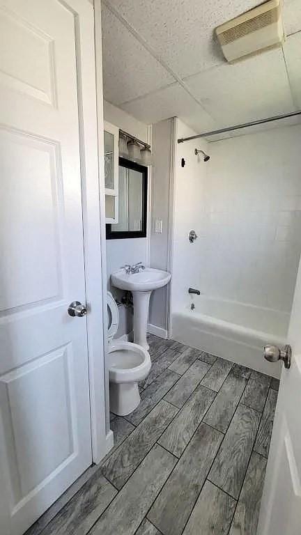 274 Harrison St, Fall River, MA 02723 - full bathroom featuring tub / shower combination, wood tiled floors, and a paneled ceiling