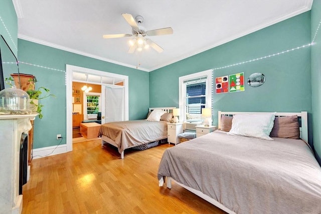 17 Teel St Unit 1, Arlington, MA 02474 - bedroom featuring wood finished floors, ornamental molding, ceiling fan, and a fireplace