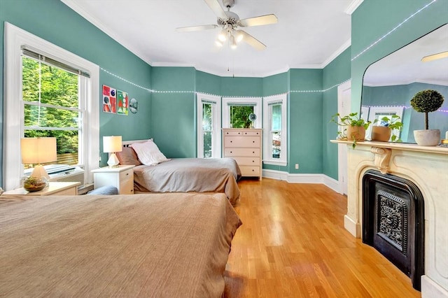 17 Teel St Unit 1, Arlington, MA 02474 - bedroom with wood finished floors, multiple windows, crown molding, a fireplace, and ceiling fan