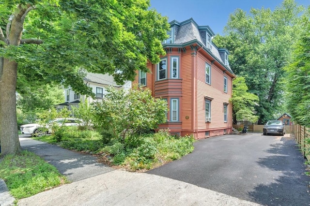 17 Teel St Unit 1, Arlington, MA 02474 - view of home's exterior featuring mansard roof and asphalt driveway