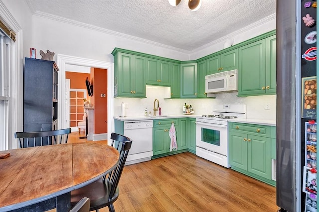 17 Teel St Unit 1, Arlington, MA 02474 - kitchen with white appliances, a textured ceiling, light countertops, light wood-type flooring, and backsplash