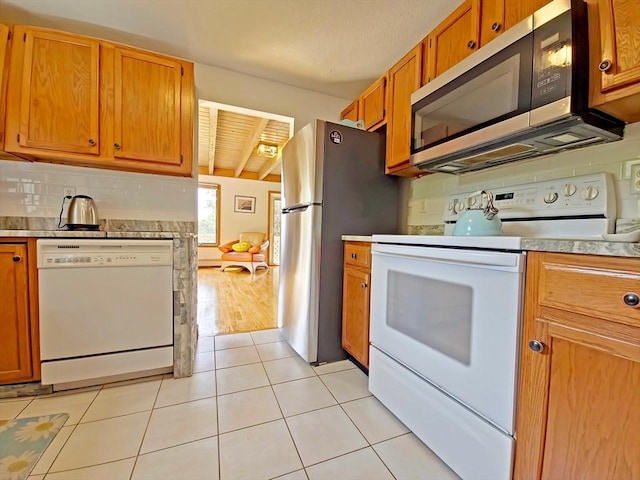 30 Norris Path, Falmouth, MA 02536 - kitchen featuring stainless steel appliances, light countertops, brown cabinetry, and light tile patterned flooring