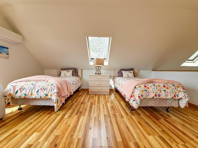 30 Norris Path, Falmouth, MA 02536 - bedroom with an AC wall unit, wood finished floors, vaulted ceiling, and a skylight