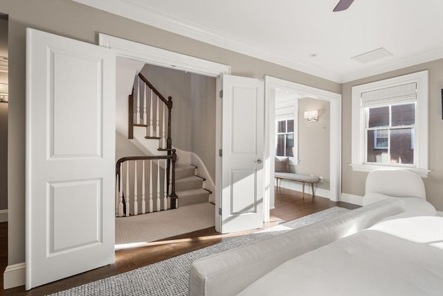 bedroom with crown molding and dark wood-type flooring