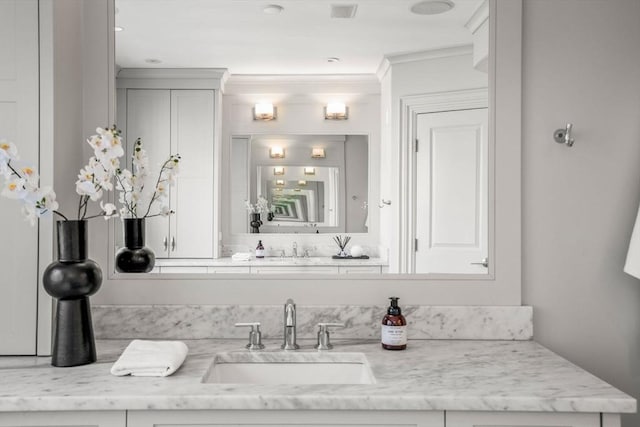 bathroom featuring vanity and crown molding