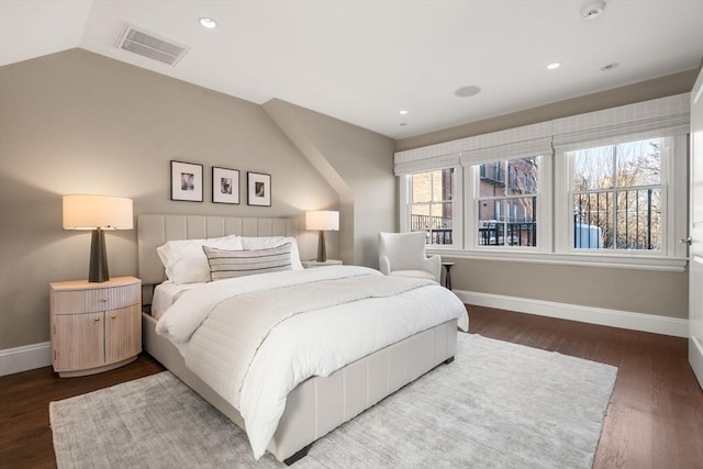 bedroom with dark wood-type flooring and vaulted ceiling