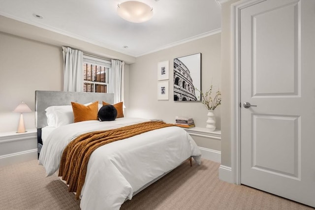 bedroom with crown molding and light carpet