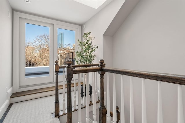 staircase featuring a skylight