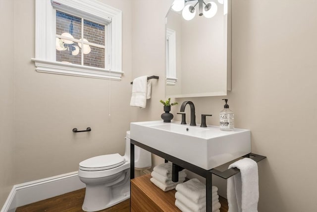 bathroom featuring wood-type flooring and toilet