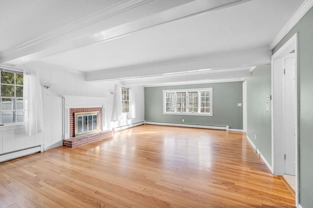 unfurnished living room with baseboard heating, light hardwood / wood-style flooring, beamed ceiling, and a brick fireplace