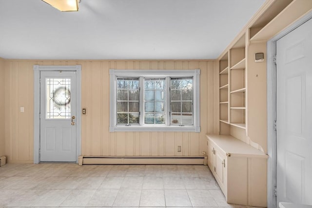 entryway with a healthy amount of sunlight, wooden walls, and a baseboard radiator