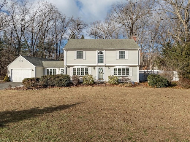 view of front facade with a front lawn and a garage