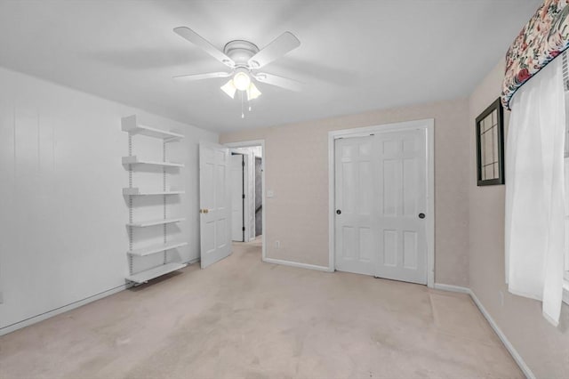 unfurnished bedroom featuring light colored carpet and ceiling fan