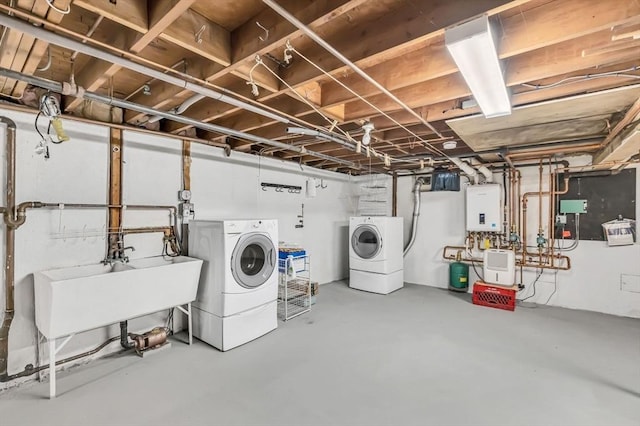 interior space with washer and dryer, sink, and tankless water heater