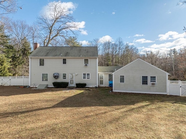 rear view of property with a lawn