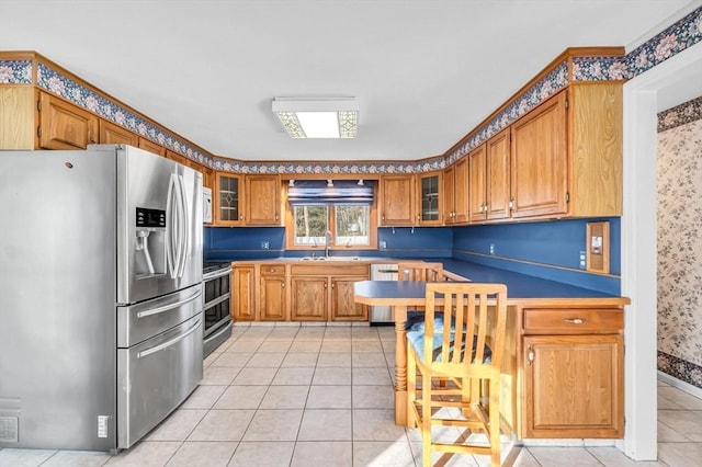 kitchen featuring light tile patterned floors, sink, and appliances with stainless steel finishes