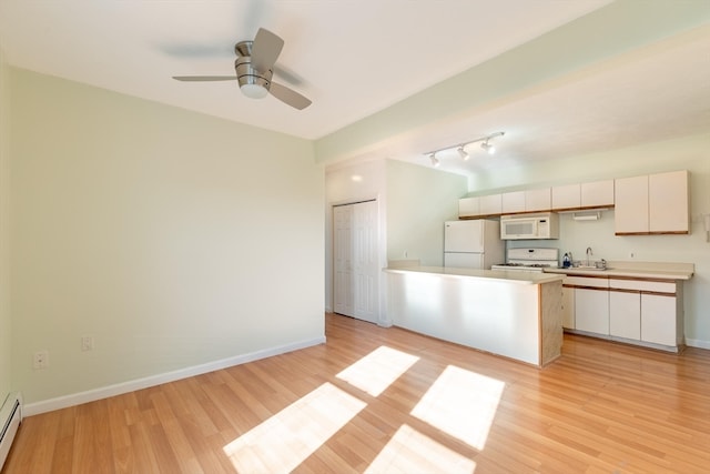 kitchen featuring ceiling fan, sink, a baseboard radiator, light hardwood / wood-style flooring, and white appliances