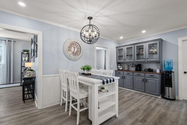 kitchen with wooden counters, gray cabinets, crown molding, and wood finished floors