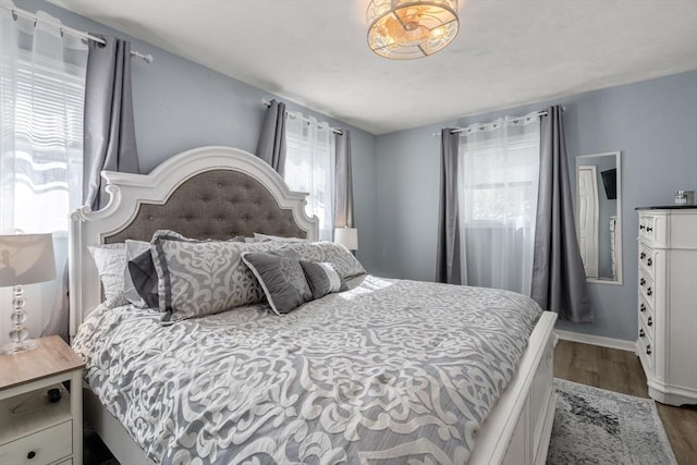 bedroom featuring baseboards and wood finished floors