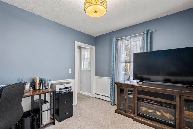 office space featuring light carpet, a textured ceiling, and a baseboard radiator