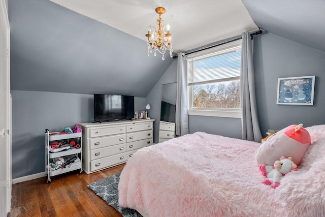 bedroom featuring lofted ceiling, wood-type flooring, baseboards, and a chandelier